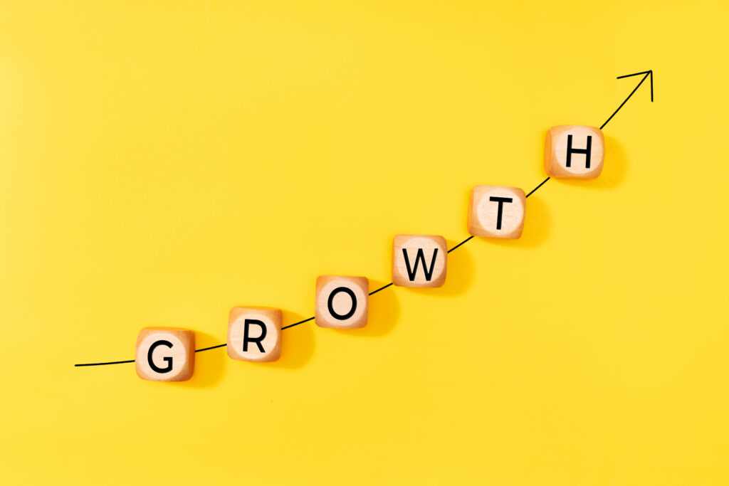 Rising growth chart made from letter blocks, highlighting momentum and new growth opportunities.