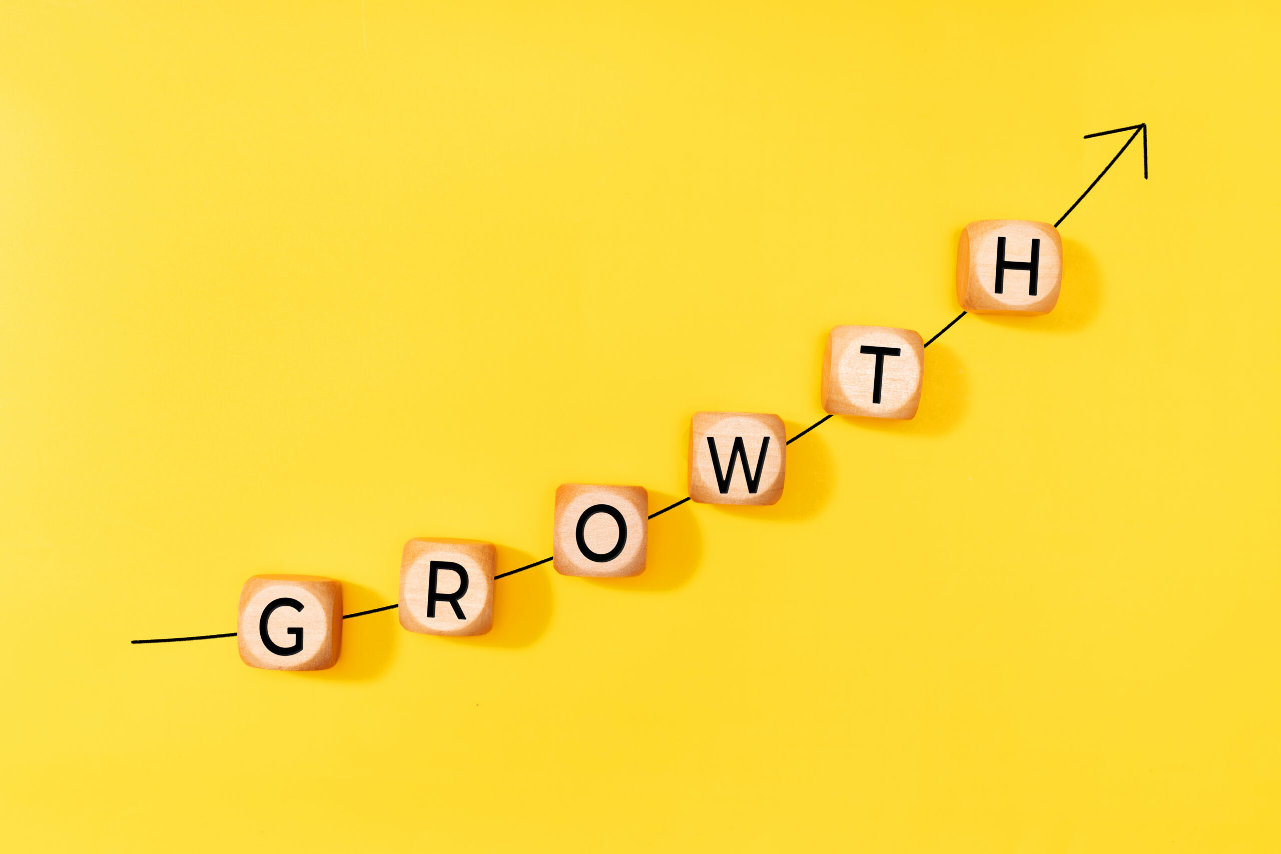 Rising growth chart made from letter blocks, highlighting momentum and new growth opportunities.