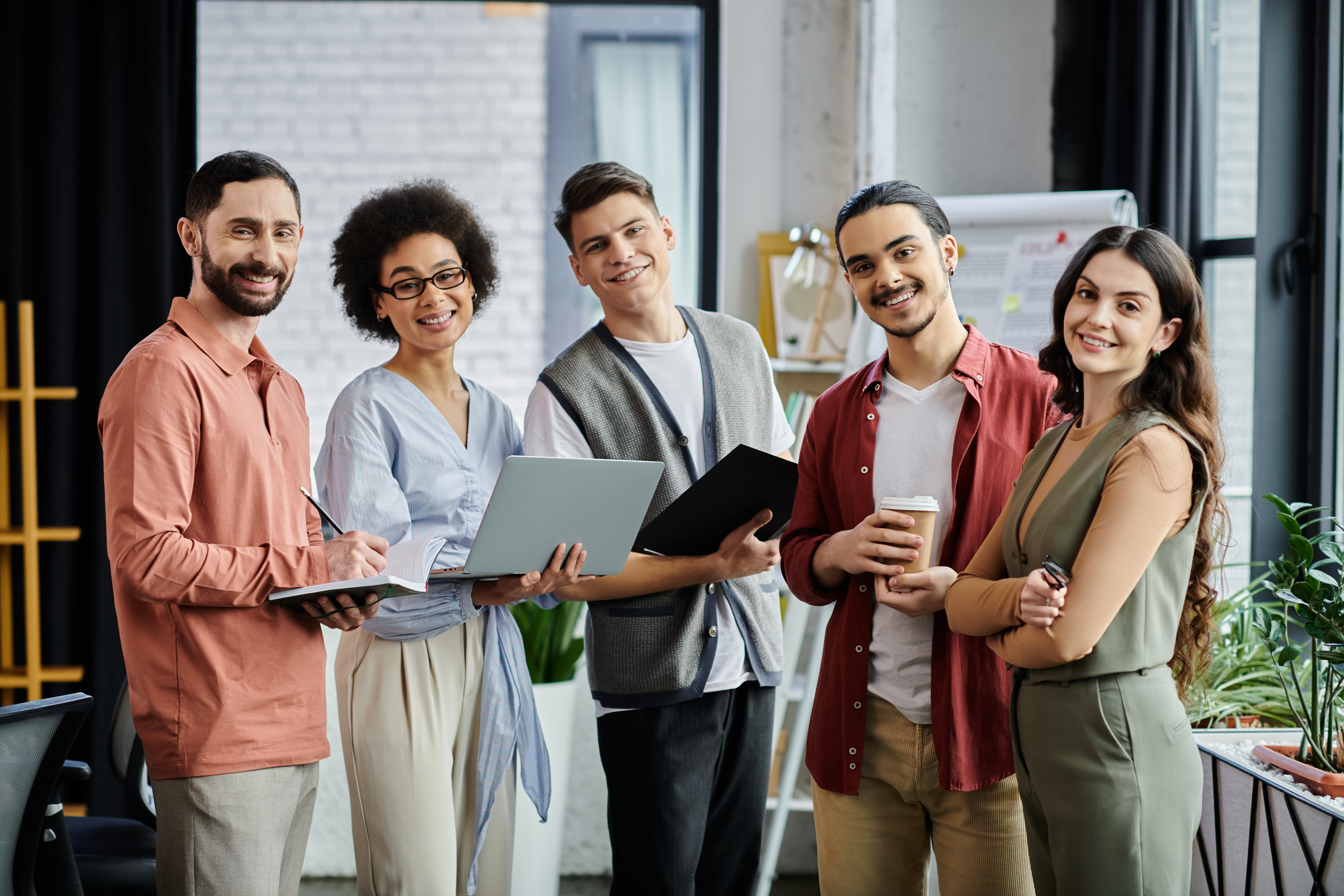 A diverse marketing team standing together, showcasing collaboration, creativity, and shared goals.